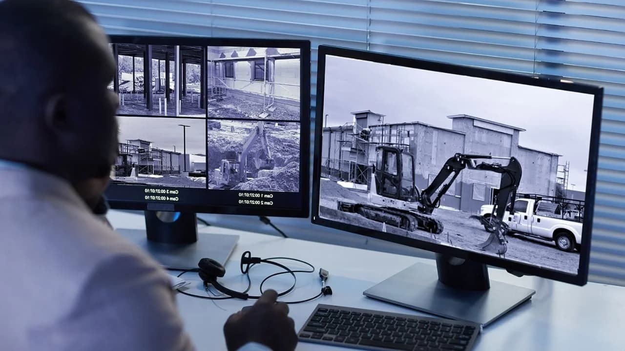 Security monitoring center with operators watching live video feeds